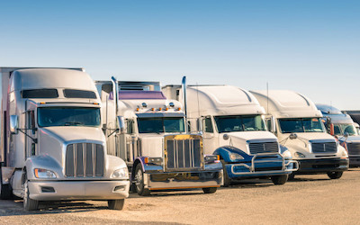 White Tractor trailers in line truck stop fuel taxes