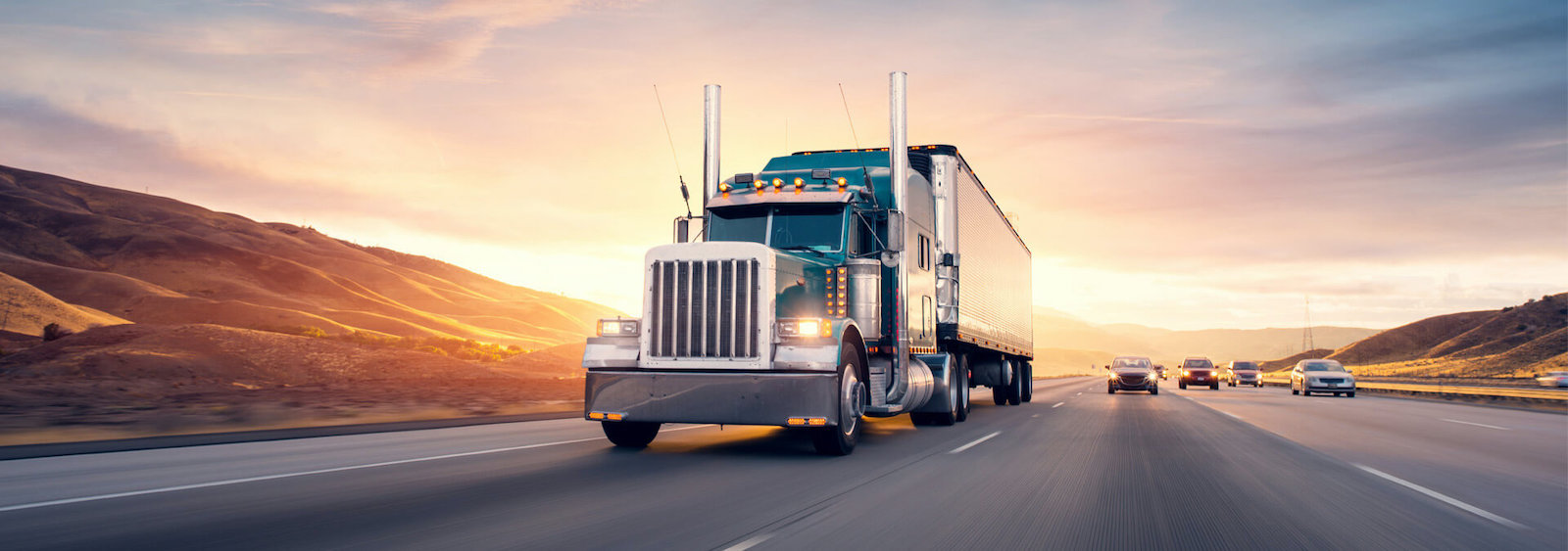 tractor trailer driving on highway at sunset website banner