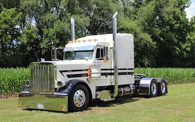 insured tractor trailer driving on highway at sunset truck insurance